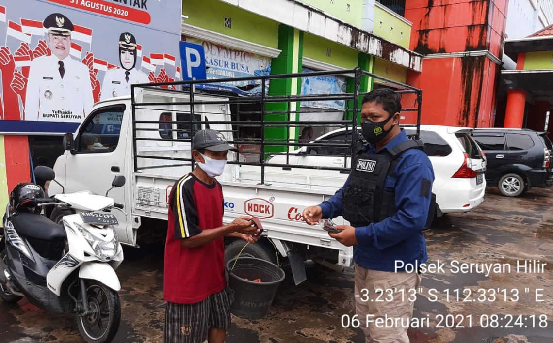 Personil Polsek Seruyan Hilir Polres Seruyan membagikan masker kepada warga sebagai antisipasi Covid-19, Sabtu (6/2/2021). Foto : Tbn